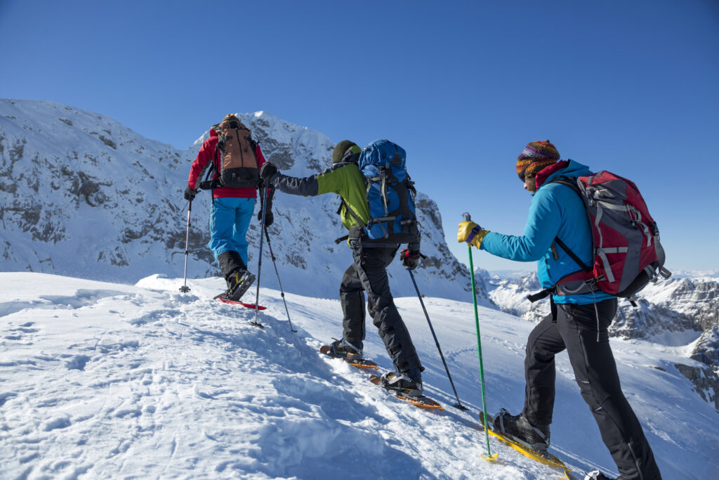 Men hiking on snow covered landscape